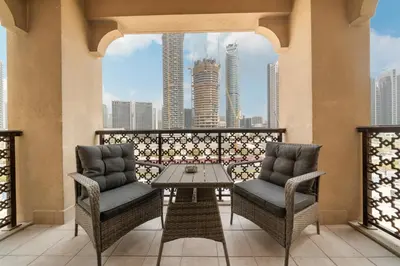 two chairs and a table on a balcony with a view at 5 Minutes Dubai Mall - Burj Khalifa - View pools in Dubai