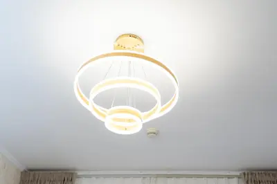 a light fixture hanging from a ceiling in a room at 5 Minutes Dubai Mall - Burj Khalifa - View pools in Dubai