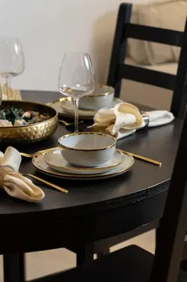 a table with plates and wine glasses on it at 5 Minutes Dubai Mall - Burj Khalifa - View pools in Dubai
