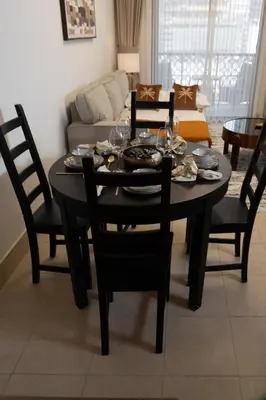 a black dining room table with chairs and a couch at 5 Minutes Dubai Mall - Burj Khalifa - View pools in Dubai