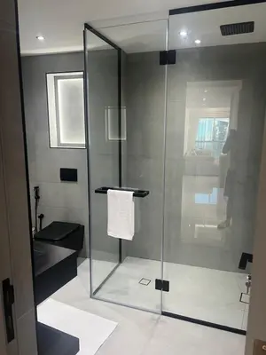 a bathroom with a shower with a glass door at Stunning Modern 1BR Apartment Lake View JLT Lake Terrace in Dubai