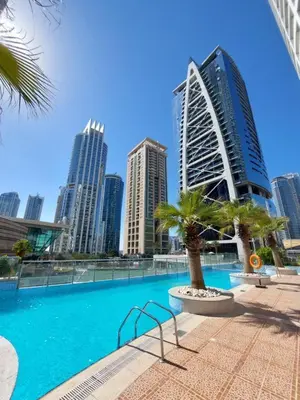 a swimming pool in a city with tall buildings at Stunning Modern 1BR Apartment Lake View JLT Lake Terrace in Dubai