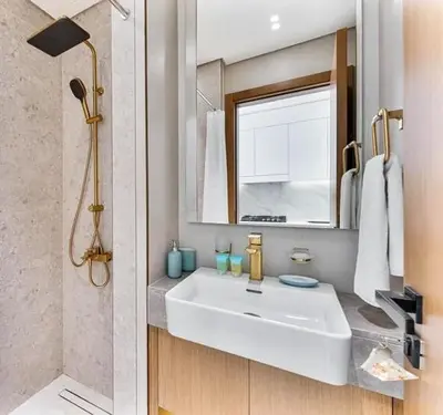 a bathroom with a white sink and a mirror at 15 min from Dubai Marina & JBR beach Studio apartment AZURE BINGHATTI JVC in Dubai