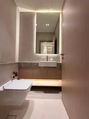a bathroom with a white toilet and a mirror at The Royale Mocha Jacuzzi Suite 34-10 I JVC I Dar Oasis in Dubai