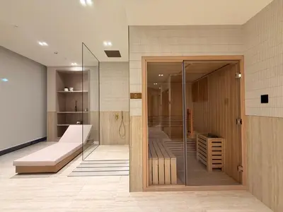 a room with a glass door and a couch in a room at The Royale Mocha Jacuzzi Suite 34-10 I JVC I Dar Oasis in Dubai