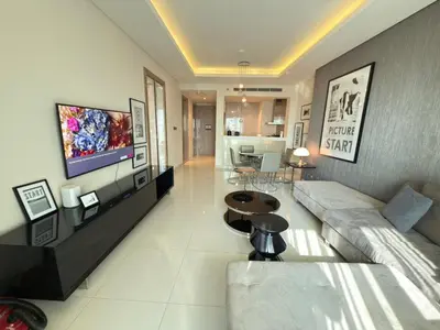 a living room with a couch and a tv at AMAKIN Damac Paramount in Dubai