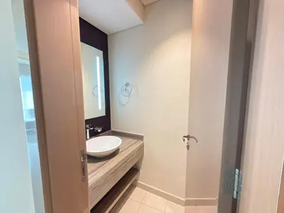 a bathroom with a sink and a mirror at AMAKIN Damac Paramount in Dubai