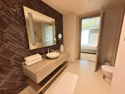 a bathroom with a sink and a mirror and a toilet at AMAKIN Damac Paramount in Dubai