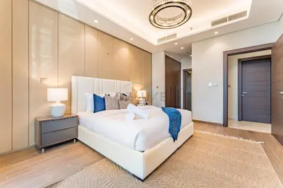 a bedroom with a large white bed with blue pillows at City Living with Street Views, Just a Walk to Bus Stop, Easy Transport to Burj Khalifa and Dubai Mall, Nobles Tower, Business Bay by Deluxe Holiday Homes in Dubai