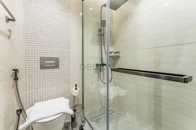 a bathroom with a glass shower with a toilet at City Living with Street Views, Just a Walk to Bus Stop, Easy Transport to Burj Khalifa and Dubai Mall, Nobles Tower, Business Bay by Deluxe Holiday Homes in Dubai