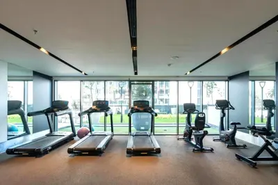 a gym with a bunch of exercise bikes in it at City Living with Street Views, Just a Walk to Bus Stop, Easy Transport to Burj Khalifa and Dubai Mall, Nobles Tower, Business Bay by Deluxe Holiday Homes in Dubai