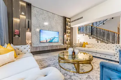 a living room with a couch and a table at 4BR plus Maids Room Villa Near Nad Al Sheba Mall, With Easy Access to Major Dubai Attractions - Nad Al Shiba Third, Nad Al Sheba by Deluxe Holiday Homes in Dubai