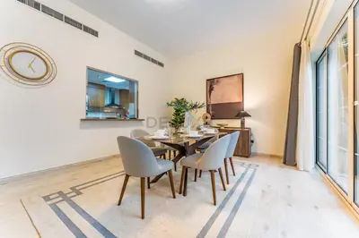 a dining room with a table and chairs at 4BR plus Maids Room Villa Near Nad Al Sheba Mall, With Easy Access to Major Dubai Attractions - Nad Al Shiba Third, Nad Al Sheba by Deluxe Holiday Homes in Dubai