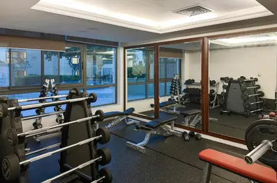 a gym with treadmills and machines in a building at Modern Retreat in The Views with Balcony & Pool in Dubai