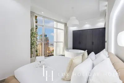 a living room with a couch and a large window at LUX The Sky Dubai Eye View Suite in Dubai