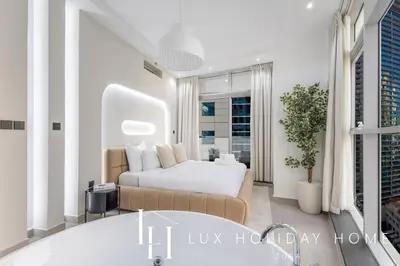 a bedroom with a bed and a bath tub at LUX The Sky Dubai Eye View Suite in Dubai