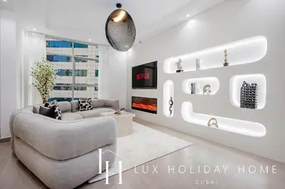 a living room with a couch and a tv at LUX The Sky Dubai Eye View Suite in Dubai
