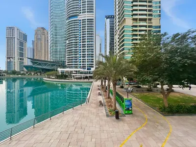 a city with tall buildings and a body of water at Modern 1BR by the Lake Near DMCC Metro Station in Dubai