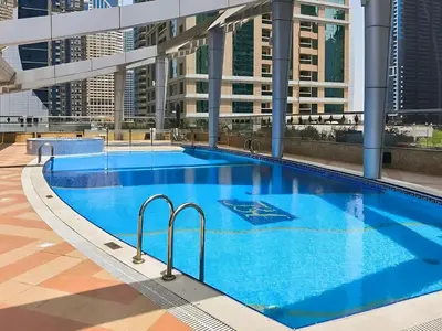 a large swimming pool on the roof of a building at Modern 1BR by the Lake Near DMCC Metro Station in Dubai