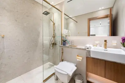 a bathroom with a shower and a toilet and a sink at Close to Community Park, Minutes Walk from Circle Mall, and Short Drive to Dubai Miracle Garden and Butterfly Garden - Binghatti Amber, JVC by Deluxe Holiday Homes in Dubai
