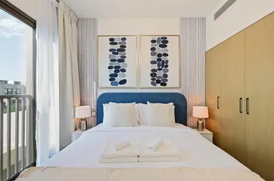 a bedroom with a large white bed with two pillows at Golden Stays - Luxe 4BR Villa Family-Friendly and Fully Equipped in Dubai