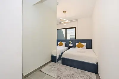 a bedroom with a blue bed and a mirror at Golden Stays - Luxe 4BR Villa Family-Friendly and Fully Equipped in Dubai
