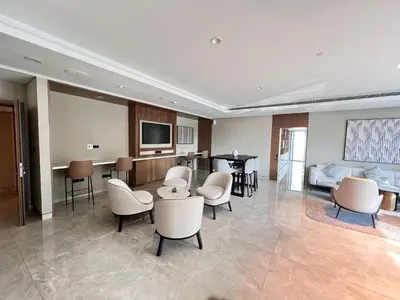 a hospital room with chairs and a couch and a television at Act Tower 410 in Dubai