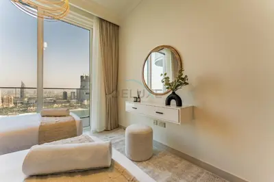 a bedroom with a large window and a mirror at Direct Private Beach Access, Proximity To Key Dubai Attractions Like Dubai Marina, Palm Jumeirah, And JBR Walk - Palace Beach Residence Tower 2, Emmar Beachfront by Deluxe Holiday Homes in Dubai