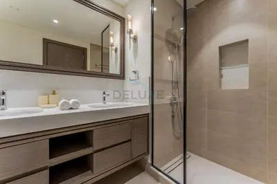 a bathroom with a sink and a shower at Direct Private Beach Access, Proximity To Key Dubai Attractions Like Dubai Marina, Palm Jumeirah, And JBR Walk - Palace Beach Residence Tower 2, Emmar Beachfront by Deluxe Holiday Homes in Dubai