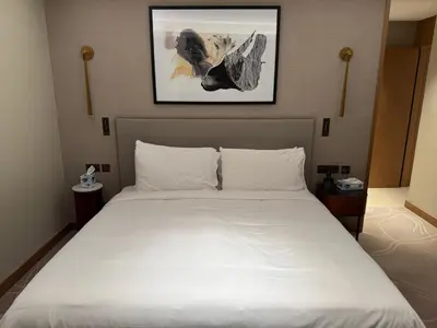 a bedroom with a large white bed in a room at Address Opera in Dubai