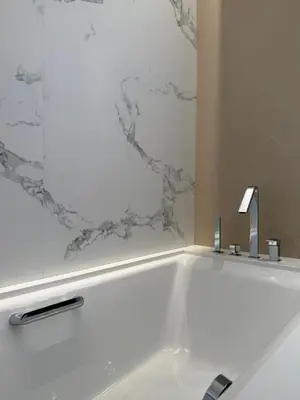 a white bath tub with a faucet in a bathroom at Address Opera in Dubai