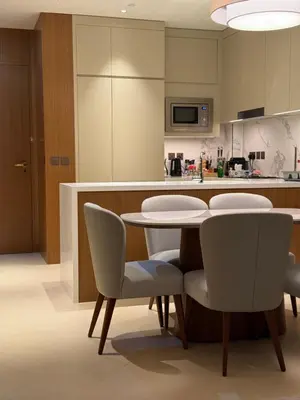 a kitchen with a table and chairs in a room at Address Opera in Dubai