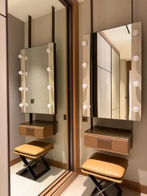 a bathroom with two stools and a mirror at Address Opera in Dubai