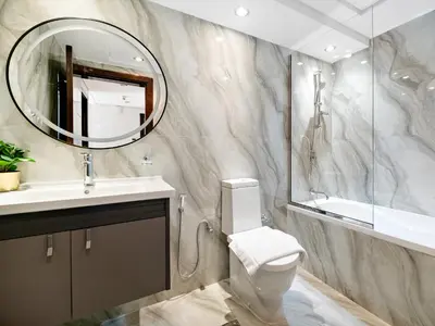 a bathroom with a toilet and a sink and a mirror at Serene 1BDR Unit -Burj Views, Downtown in Dubai