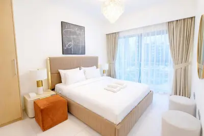 a bedroom with a large bed and a large window at Burj Khalifa View 2BR Luxury Apartment in Dubai in Dubai