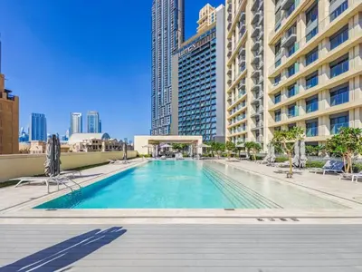 a large swimming pool in a city with tall buildings at Burj Khalifa View 2BR Luxury Apartment in Dubai in Dubai
