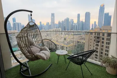 a hammock on a balcony with a view of a city at Burj Khalifa View 2BR Luxury Apartment in Dubai in Dubai