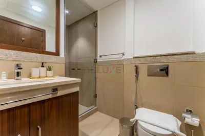 a bathroom with a shower and a toilet and a sink at High Floor with Direct Burj Khalifa and Fountain Views, Just Steps from Dubai Mall and Metro Station - Burj Vista Tower 1, Downtown Dubai by Deluxe Holiday Homes in Dubai