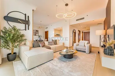 a living room with a couch and a table at High Floor with Direct Burj Khalifa and Fountain Views, Just Steps from Dubai Mall and Metro Station - Burj Vista Tower 1, Downtown Dubai by Deluxe Holiday Homes in Dubai