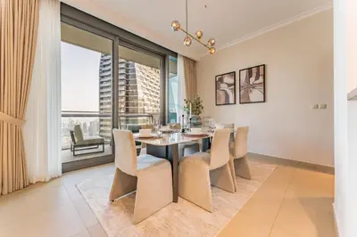 a dining room with a table and chairs and a large window at High Floor with Direct Burj Khalifa and Fountain Views, Just Steps from Dubai Mall and Metro Station - Burj Vista Tower 1, Downtown Dubai by Deluxe Holiday Homes in Dubai