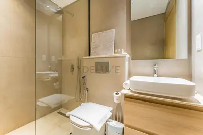 a bathroom with a sink and a toilet and a shower at Walking Distance to Miracle Garden and Butterfly Garden, 20 Minutes Drive to Dubai Marina and Palm Jumeirah - Divine Living, Arjan, by Deluxe Holiday Homes in Dubai