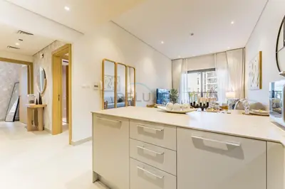 a kitchen with white cabinets and a counter top at Walking Distance to Miracle Garden and Butterfly Garden, 20 Minutes Drive to Dubai Marina and Palm Jumeirah - Divine Living, Arjan, by Deluxe Holiday Homes in Dubai