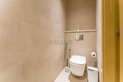 a bathroom with a white toilet in a room at Walking Distance to Miracle Garden and Butterfly Garden, 20 Minutes Drive to Dubai Marina and Palm Jumeirah - Divine Living, Arjan, by Deluxe Holiday Homes in Dubai