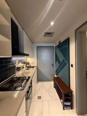 a kitchen with a stove and a door in it at Furnished Studio 2 min Walk to Burji Khalifa in Dubai