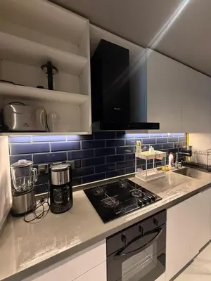 a kitchen with a stove and a counter top at Furnished Studio 2 min Walk to Burji Khalifa in Dubai
