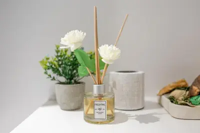 a glass jar with flowers in it on a table at Luxurious 1BR Modern Apartment Balcony Pool in Dubai