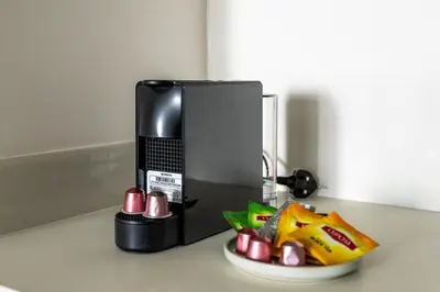 a coffee maker and a bowl of food on a counter at Luxurious 1BR Modern Apartment Balcony Pool in Dubai