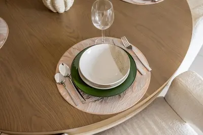 a wooden table with a plate and a wine glass at Luxurious 1BR Modern Apartment Balcony Pool in Dubai