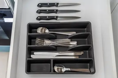 a drawer full of utensils in a refrigerator at Luxurious 1BR Modern Apartment Balcony Pool in Dubai