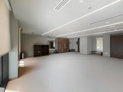 an empty room with a large room with a large room at Luxurious 1BR Modern Apartment Balcony Pool in Dubai